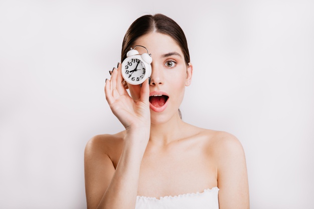 close-up-portrait-beautiful-lady-with-white-alarm-clock-covering-her-eyes-no-makeup_197531-13876